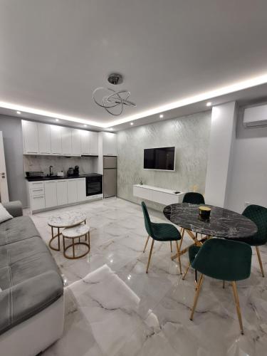 a living room with a couch and a table at Sandanski park view in Sandanski