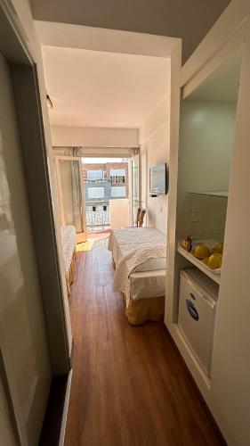 a small room with a bed and a window at Hotel Tamariz in Piriápolis