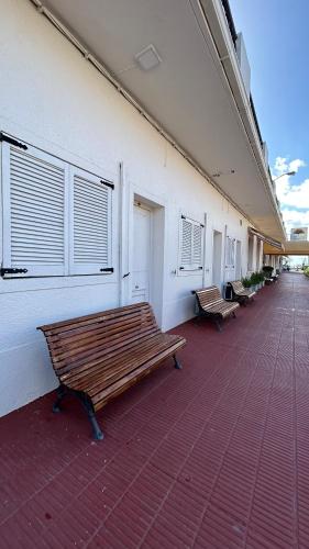a row of benches on the side of a building at Hotel Tamariz in Piriápolis
