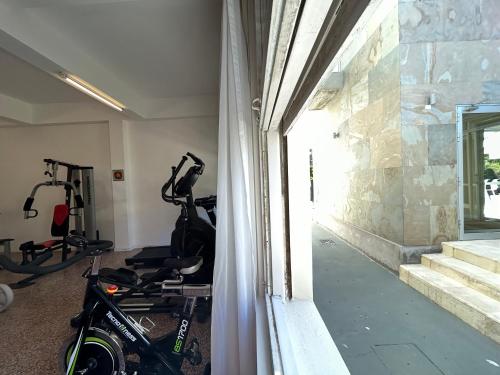 a room with a gym with tread machines in it at Hotel Tamariz in Piriápolis