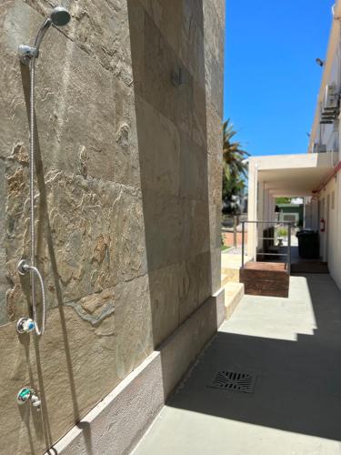 a shower on the side of a building at Hotel Tamariz in Piriápolis