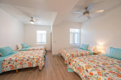 a room with two beds and a ceiling fan at Class & Space Uptown in Charlotte