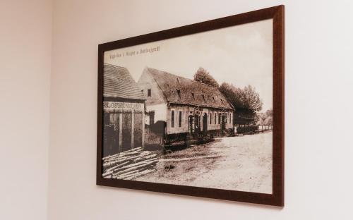 a black and white picture of a building on a wall at Pansion Mihića dvori in Babina Greda