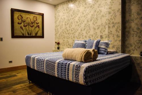 a bedroom with a bed with a teddy bear on it at Montecielo Hosting in Guatapé