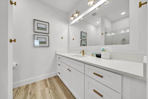 a white bathroom with a sink and a mirror at Pinkie Preferred Property Private Heated Pool Emerald Escape in Destin