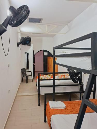 a room with two bunk beds and a hallway at La Rivera Playa Palomino in Palomino