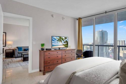 a bedroom with a bed and a large window at Icon 39th Floor 1 Bedroom apartment- Bay & City View- FREE SPA in Miami