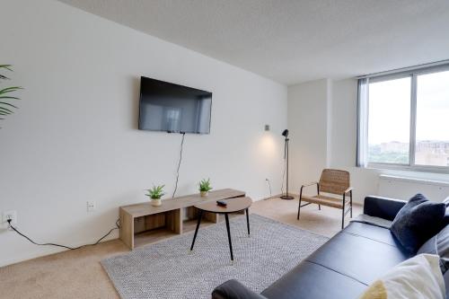a living room with a couch and a table at Incredible 1 BR Apt + Den @Crystal City With Gym in Arlington