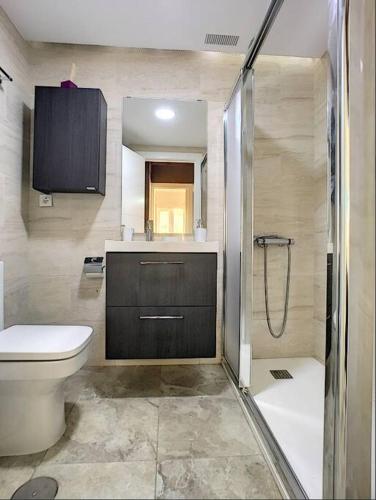 a bathroom with a toilet and a sink and a shower at 3 bed ground first floor apartment. Close to beach in Mar de Cristal