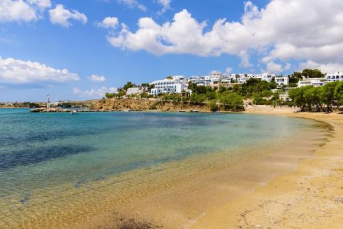a view of a beach with buildings in the background at Dolce Vita Waterfront Villa, Logaras, Paros in Kampos Paros