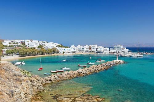a group of boats in the water on a beach at Dolce Vita Waterfront Villa, Logaras, Paros in Kampos Paros