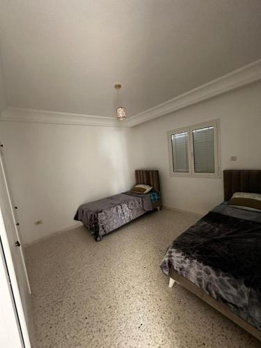 a bedroom with two beds and a window at Dar Lamis in Houmt Souk