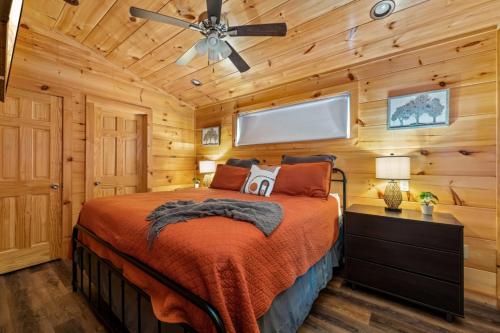 a bedroom with a bed and a ceiling fan at Rustic Mountain Retreat by Ghosal Luxury Lodging in Pigeon Forge