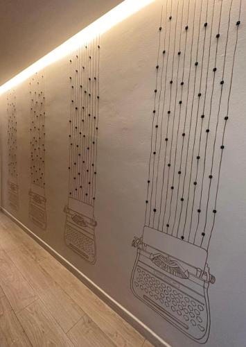 a wall with two harps on it at Borgo Yporegia in Ivrea