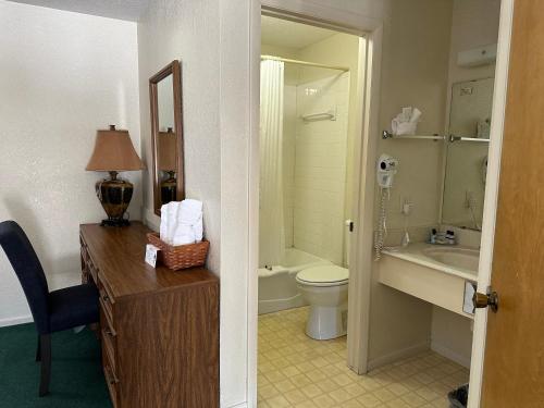 a bathroom with a toilet and a sink at Sunset Inn and Suites in Fredericksburg