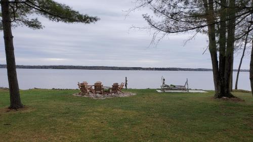 a picnic table and bench next to a lake at Lilly Pay11 in Crivitz