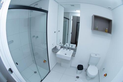 a bathroom with a shower and a toilet and a sink at ST Studios Vila Mariana by Housi in Sao Paulo