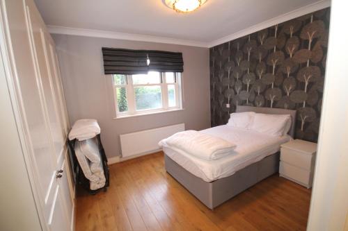 a small bedroom with a bed and a window at Harrow On The Hill Place in London
