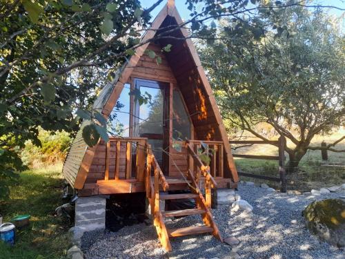 a tree house with a staircase and a swing at Carlingford Mountain Farm in Dundalk