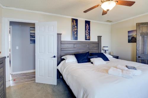 a bedroom with a large white bed with blue pillows at Oceanfront Milford Home with View and Boat Access in Milford