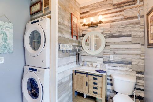 a bathroom with a washer and dryer on the wall at Oceanfront Milford Home with View and Boat Access in Milford