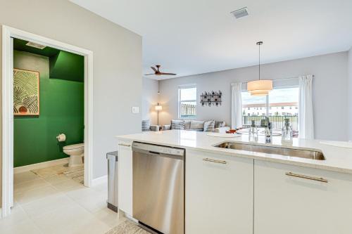 a white kitchen with a sink and a toilet at Idyllic Miami Townhome with Grill and Lake Views in Miami