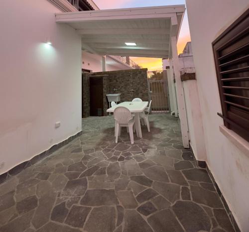 a patio with a table and chairs on a floor at Dimora San Nicola in Racale