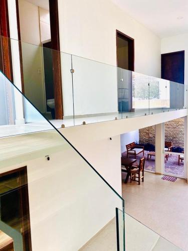 a glass staircase in a house with a living room at Cekalli in León