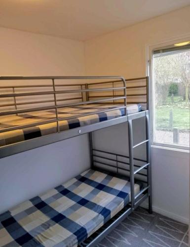 two bunk beds in a room with a window at Relax huset in Malmö