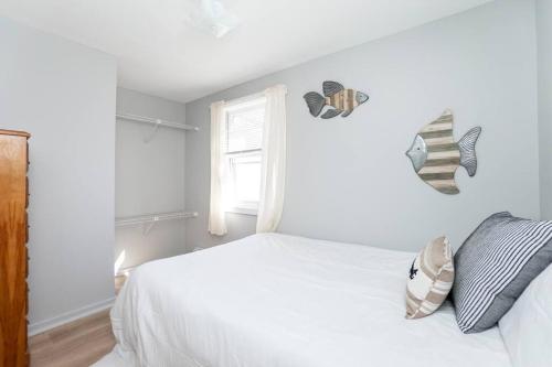 a white bedroom with a bed and a window at Hampton Beach Seaside Villa Unit 2 in Hampton