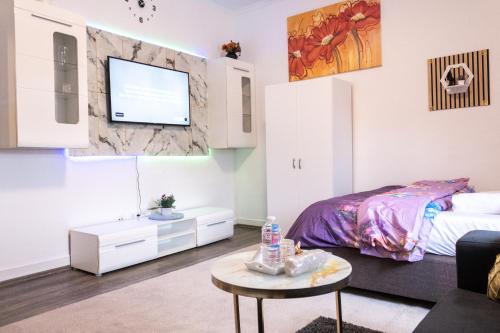 a bedroom with a bed and a tv on a wall at Superior 3 rooms, 4-8 guests, modern, Full equipped in Duisburg