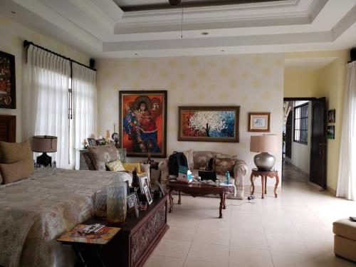 Habitación grande con cama grande y sofá en Casa en Samborondón en Guayaquil