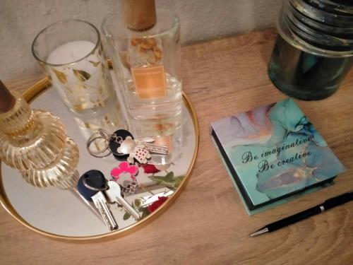 a table topped with a plate with keys and a glass at 2BDR Downtown Veria Peach Blossom in Veria