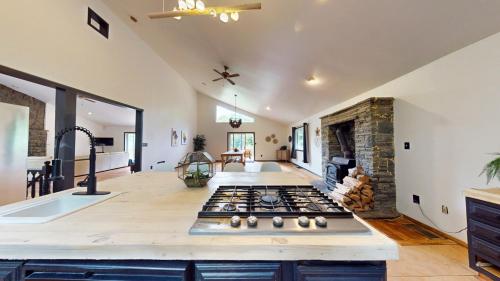 a kitchen with a stove top oven in a room at The Stone Mason - Large Modern Home on 5 Acres - 2 Hrs from NYC in Pond Eddy
