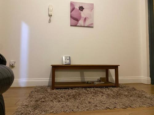 a coffee table on a rug in a living room at Single Room in CV1 Fargo Village Room with Shared bathroom in Coventry