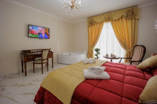 a bedroom with a large bed with towels on it at REDDIMUS Guest House in Naples