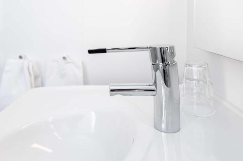 a bathroom sink with a chrome water faucet at Scandic Kokstad in Bergen