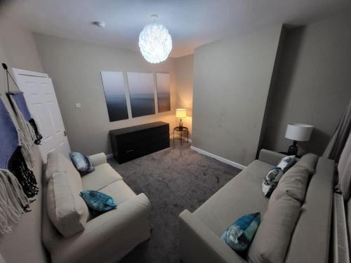 a living room with two couches and a television at 4 Bedrooms, 8 min to Manchester City! in Manchester