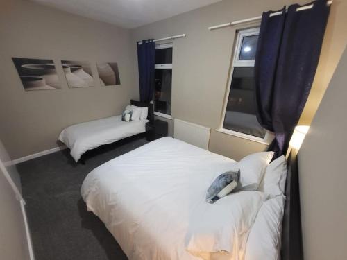 a bedroom with two beds and a window at 4 Bedrooms, 8 min to Manchester City! in Manchester