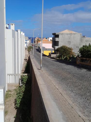 an empty street next to a white building at AP Hélder Bentub in Ponta do Sol