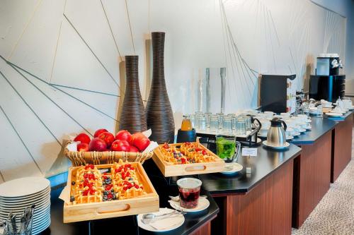 a buffet with two trays of food on a table at Park Inn by Radisson Lübeck in Lübeck