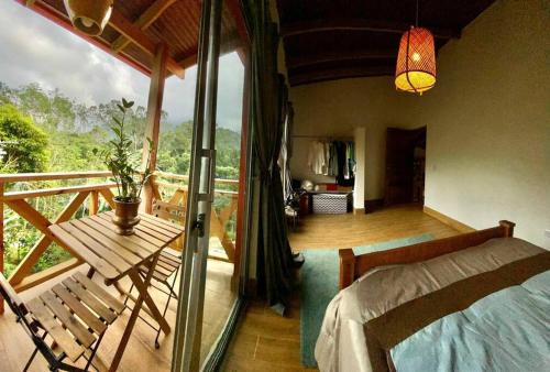 a bedroom with a balcony with a bed and a table at Villa Tortuga Constanza in Constanza