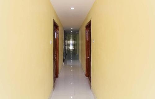 a hallway with yellow walls and a long corridor at Collection O Sree Guru Lakshmi Residency in Tirupati