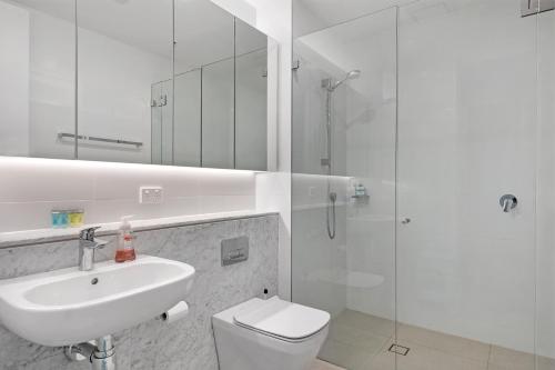 a bathroom with a toilet and a sink and a shower at Central location one bedroom in Chatswood in Sydney