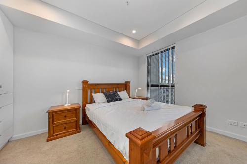 a bedroom with a wooden bed and a window at Central location one bedroom in Chatswood in Sydney