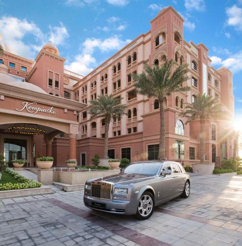 a luxury car parked in front of a building at Marsa Malaz Kempinski, The Pearl in Doha