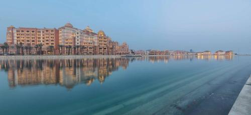 a large body of water with buildings in the background at Marsa Malaz Kempinski, The Pearl in Doha