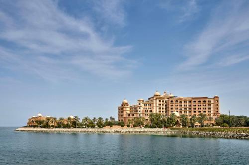 a large building in front of a large body of water at Marsa Malaz Kempinski, The Pearl in Doha