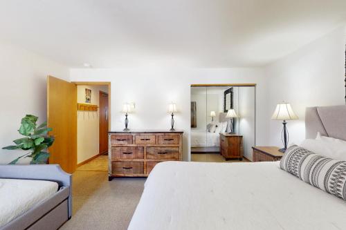 a bedroom with a bed and a dresser and a mirror at Skiers Paradise in Keystone