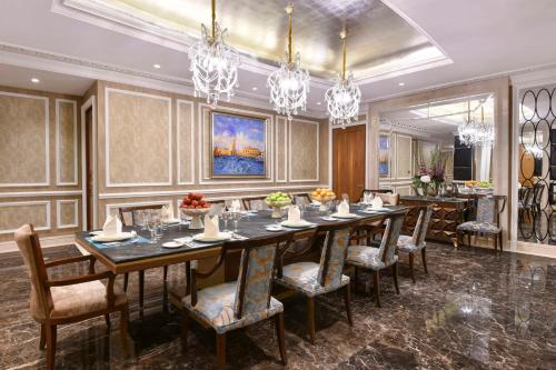 a large dining room with a long table and chairs at Marsa Malaz Kempinski, The Pearl in Doha